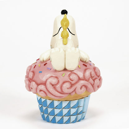 Snoopy Laying on Cupcake